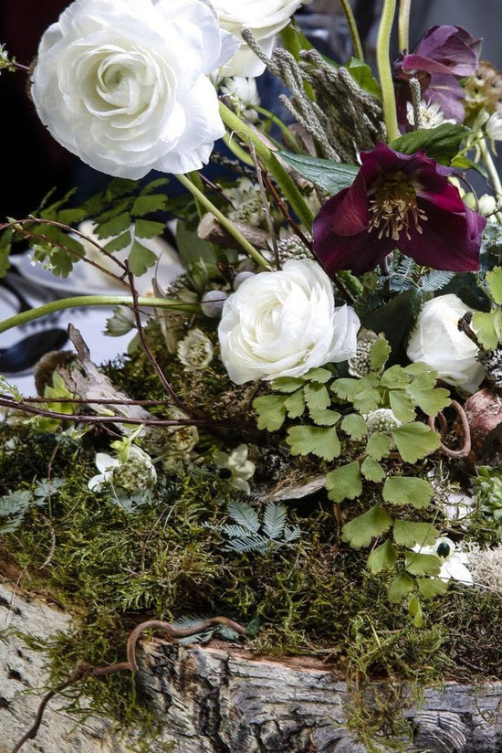 Floral arrangement on a wooden log with white and purple flowers DIY Floral Design online class